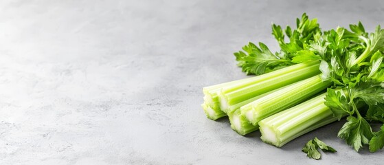 Poster -  A white counter holds a pile of celery and a bunch of green, leafy celery beside it