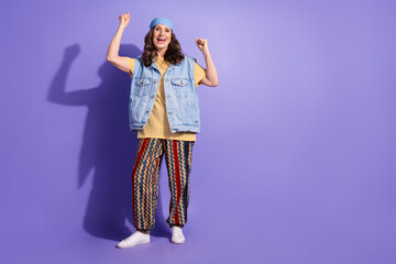 Canvas Print - Full size photo of pretty retired woman winning raise fists wear trendy denim hipster outfit isolated on violet color background