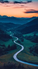 Wall Mural - Winding road leading through green hills at sunset