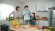 © Summit Art Creations - Caucasian skilled father, mother and asian daughter making breakfast while dancing together. Skilled mom playing ukulele while preparing vegetable at modern kitchen. Healthy food concept. Pedagogy.