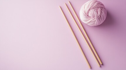 Wall Mural - A cozy scene featuring knitting needles and a ball of pink yarn on a pastel background.