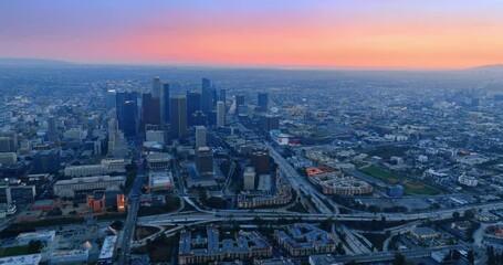 Wall Mural - Hazy vast panorama of Los Angeles, California, the USA at twilight time. Aerial perspective on the city under the pink horizon.