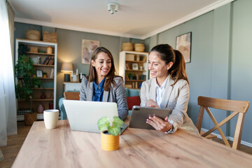 Wall Mural - Professional Women with a Digital Tablet and Laptop at Home Office