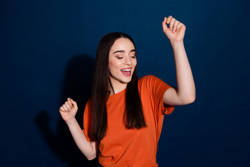 Poster - Photo of lovely adorable cheerful woman wear orange clothes good mood have fun isolated on dark blue color background