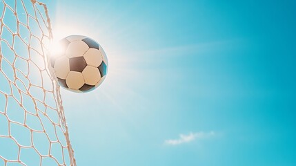 Wall Mural - Ball sinking through the net, bright clear sky above.