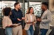 © Zamrznuti tonovi - Happy diverse causal executives working on business strategy at lobby.
