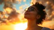 © bvbflo1 - Young woman looking up at the sky at sunset