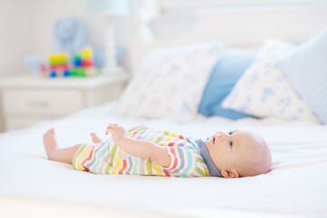 Wall Mural - little baby on white bed