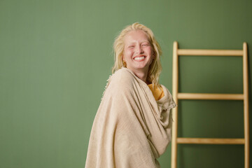 Joyful Young Woman with a Green Backdrop