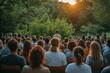 © Irina Kozel - A diverse group of people gathered in a park for earthquake safety training, facing a speaker against a sunset backdrop