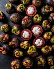 Wall Mural - Overhead view of Fresh, Pile, Ripe and juicy sweet mangosteen fruits. Halves food summer background