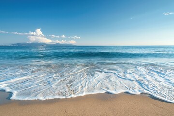 Poster - Gentle waves lap against the sandy shore of a tranquil beach during a sunny afternoon in a tropical paradise