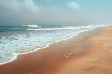 Poster - Gentle waves lap against the sandy shore of a tranquil beach during a sunny afternoon in a tropical paradise