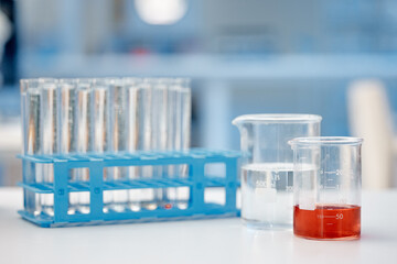 Science, test tubes and beaker on table in lab for medical research, pharmaceutical experiment and treatment. Fluid container, liquid and equipment for chemical development or chemistry investigation