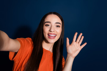 Wall Mural - Photo of adorable pretty cheerful woman wear stylish orange clothes video blog isolated on dark blue color background