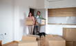 © Budimir Jevtic - Man and woman moving into new apartment