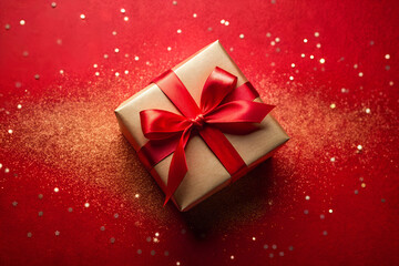 Wall Mural - red gift box with ribbon and glitter on red