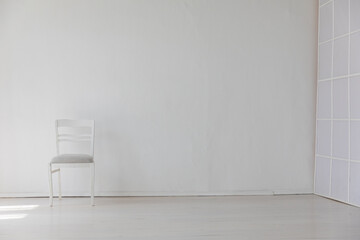 Poster - one old vintage chair in the interior of an white room