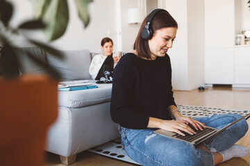 Wall Mural - Young female student having a video online lesson