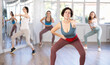 © JackF - Sporty young woman dancing modern dance at class with his friends
