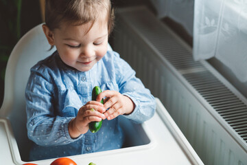 the baby is trying a new taste of solid food. eating healthy food from the beginning is important. y