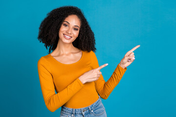 Poster - Photo portrait of pretty young girl point empty space wear trendy orange outfit isolated on blue color background