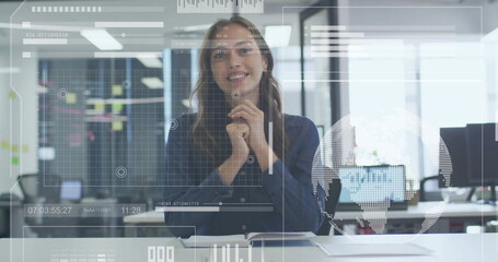 Wall Mural - Image of data processing over happy caucasian businesswoman having image call at casual office