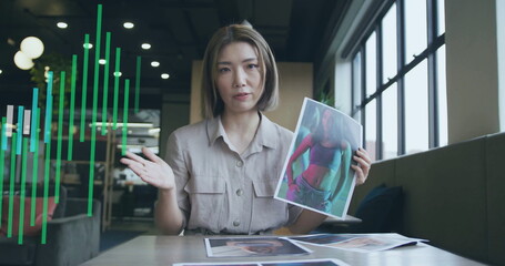 Poster - Image of graph processing data over asian female creative having image call at casual office