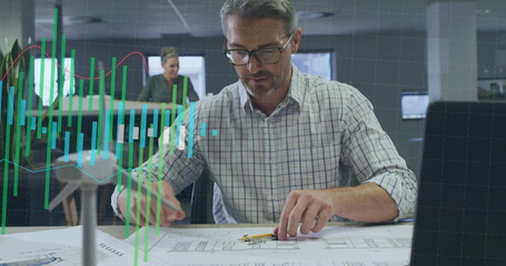 Poster - Image of graph processing data over caucasian male architect working on blueprints