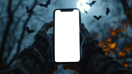 Phone mockup. A Halloween concept. A man in tattered clothes holds a stylish modern smartphone with a white screen in his hands, while bats fly in the background and a full moon