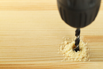 Poster - Drilling hole in wooden plank, closeup. Space for text