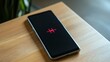 © LU - Close-up of a modern smartphone with a battery indicator showing full charge, placed on a wooden table. The background is softly blurred, focusing on the device's safety features