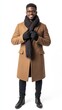 © A Denny Syahputra - A young African American man showcases cozy winter fashion, wearing a thick coat, scarf, and gloves, exuding warmth and style