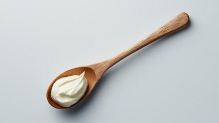 Spoonful of cream sitting on a white table