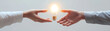 © Nakarin - image depicts two hands passing glowing light bulb, symbolizing exchange of ideas and inspiration. This moment captures essence of collaboration and creativity