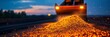 © Naru - A close-up view of a pile of gravel being unloaded by an excavator at dusk. The excavator is silhouetted against the setting sun, and the gravel is illuminated by the headlights of the machine. This i
