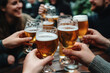 © Lazy_Bear - Hands holding beer glasses clinking together in bar. Group of friends having fun and drinking beer