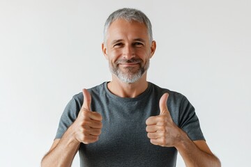 middle aged man in casual attire giving thumbs up showing success.