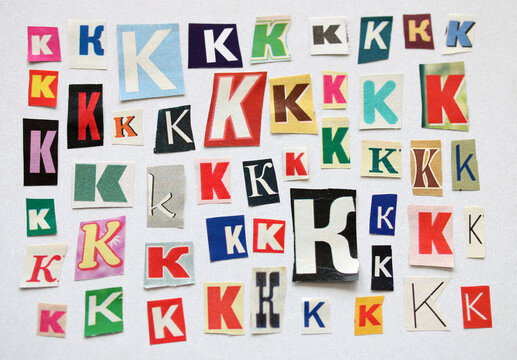 The letter K. bundle of paper letters cut out of magazines and newspapers in different sizes and fonts. white background.