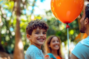 Wall Mural - High-resolution brightly lit photorealistic candid photograph of a family smiling and enjoying their time at the zoo, with the son holding a balloon, and a soft, creamy bokeh background. The