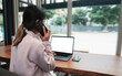 © Ton Photographer4289 - Businesswoman talking on the phone while sitting at the desk in the office. Business concept