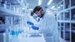 © BozStock - A scientist in a lab coat and safety glasses carefully uses a pipette to transfer liquid in a lab setting.