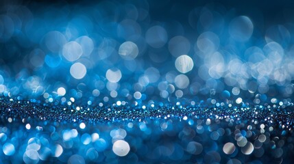 Elegant blue and white glitter abstract bokeh background evoking Christmas holiday festivities and winter wonderland