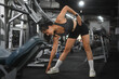 © Prathankarnpap - Flexible young woman warming up legs muscles before hard workout in gym