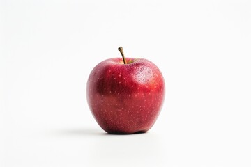 Wall Mural - A single red apple sits on a white surface, ideal for food, design or product photography