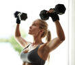 © ArcursForPI/peopleimages.com - Shoulder press, gym and woman with dumbbells for fitness, workout and exercise for arms or health. Development, serious and girl athlete lifting weights for sports, body training or muscle growth