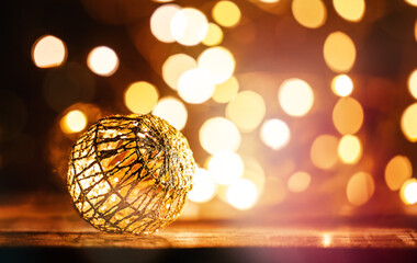 Wall Mural - Golden Christmas ornaments on glittering and defocused lights In dark background