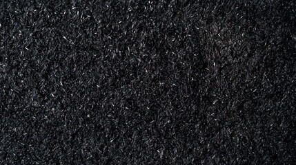 Close-up of textured black fabric, showcasing intricate fibers and a rich, dark surface.