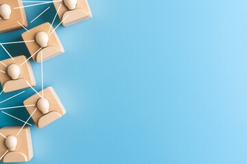 Poster - A blue background is dominated by wooden blocks interconnected in a teamwork fashion.