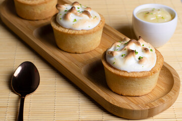 Baked tartlets with white cream and lemon, delicious dessert